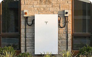 Wall-mounted home battery beside a residential window