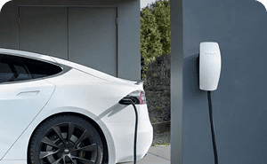 Electric vehicle connected to a wall-mounted home charger